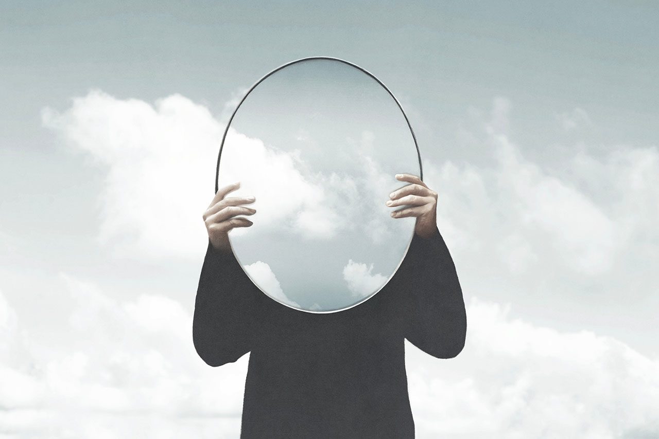 person holding up a mirror to distract from the truth