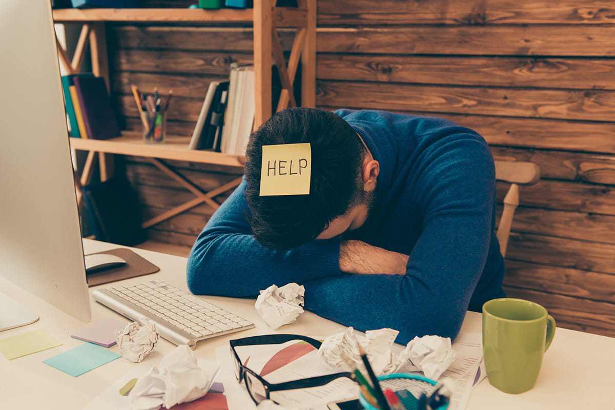 Man with a HELP sticky note on his head