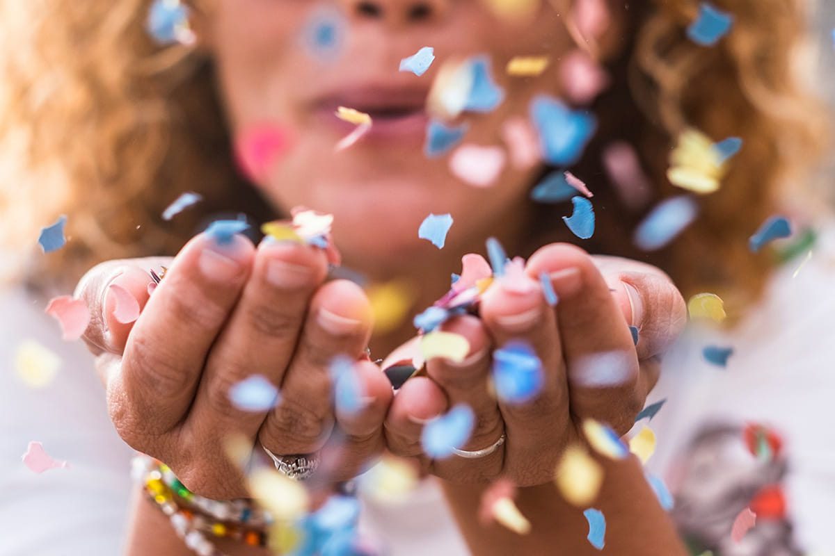 Woman blowing confetti